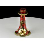 A MINTON SECESSIONIST CANDLE STICK, with tube-lined decoration, with white flower motifs on red