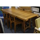 A 1970'S FRENCH OAK EXTENDING DINING TABLE AND FOUR CHAIRS, manufactured by Guillerme et Chambron,