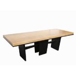 A MODERN CONTEMPORARY DINING TABLE, with tan leather top, on sculptural ebonised oak base,