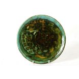 A 1960s POOLE STUDIO PLATE, ATTRIBUTED TO TONY MORRIS, in green and brown abstract glazes, blue