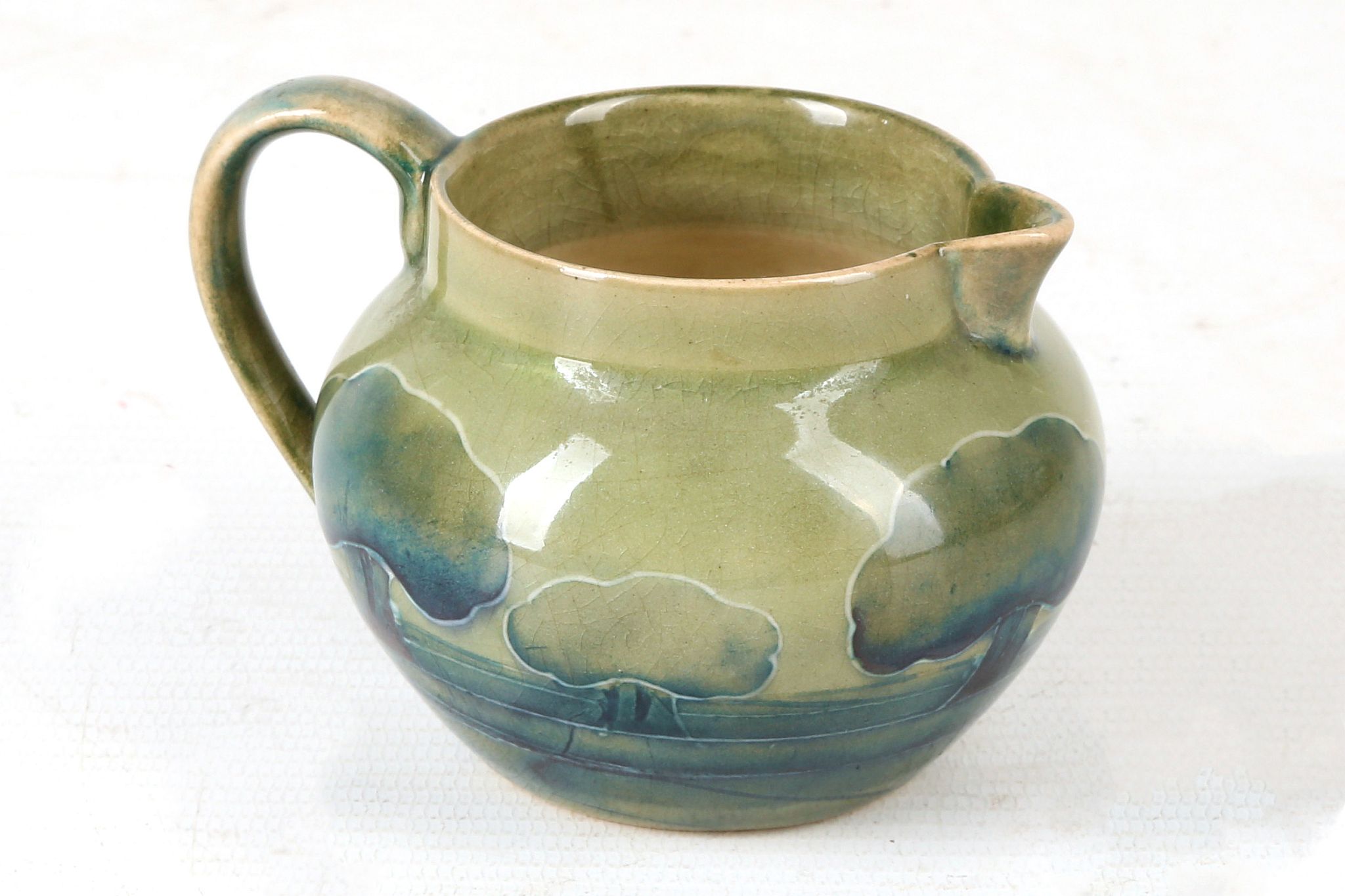 A WILLIAM MOORCROFT POTTERY MINIATURE JUG, tube-lined with trees, in 'Hazeldene' pattern, c.1920,