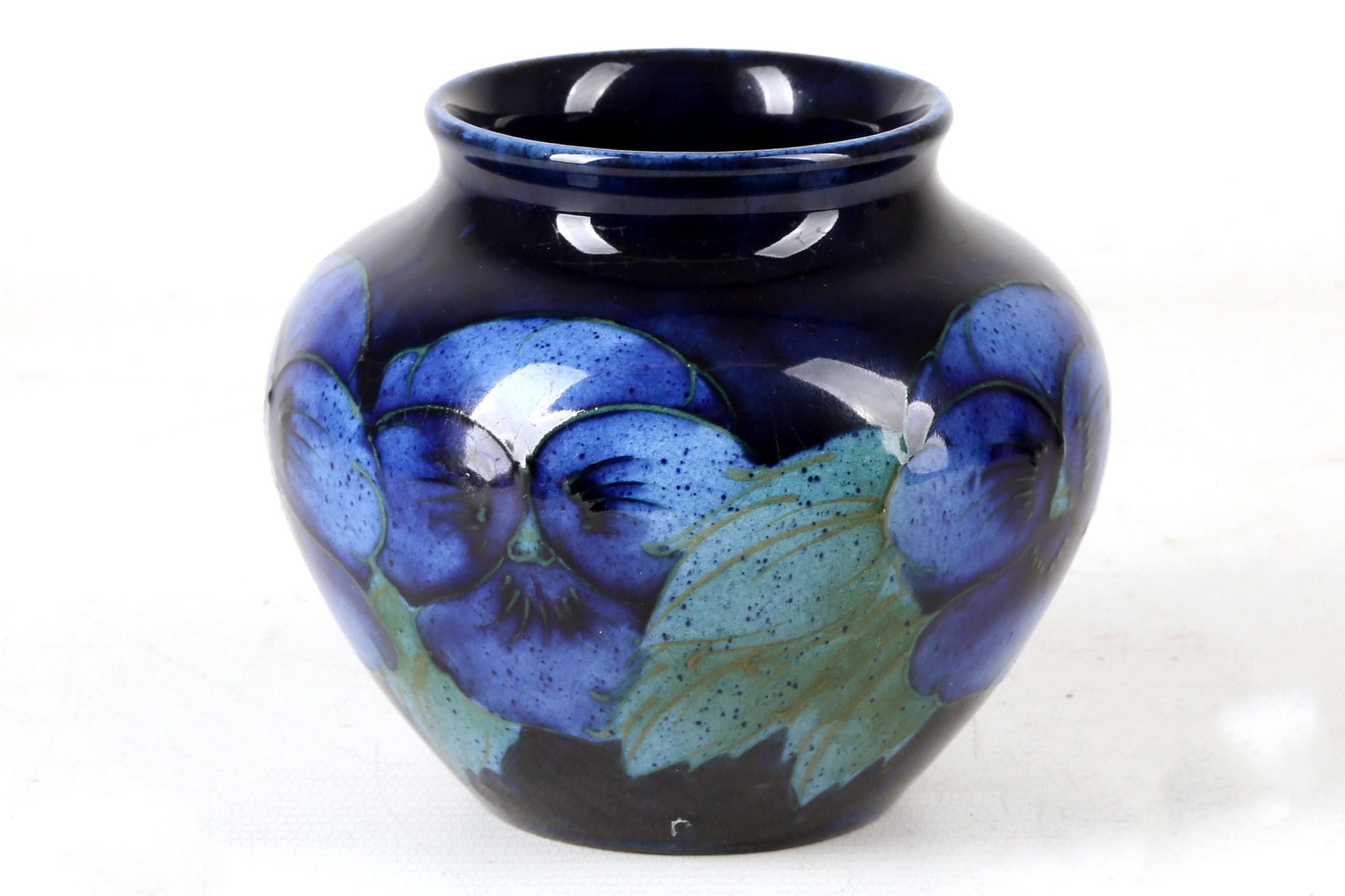 AN UNUSUAL WILLIAM MOORCROFT POTTERY BOWL, in cobalt blue, tube-lined with 'Pansy' pattern, green