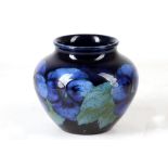 AN UNUSUAL WILLIAM MOORCROFT POTTERY BOWL, in cobalt blue, tube-lined with 'Pansy' pattern, green