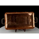 AN EARLY 20TH CENTURY WMF EMBOSSED COPPER TRAY, with brass handles, stamped with maker's mark