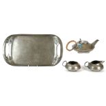 ARCHIBALD KNOX FOR LIBERTY & CO., OF LONDON, an early 20th century three piece pewter tea service on