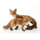 A PORCELAIN GROUP OF FOXES, manufactured by Hutschenreuter, circa 1950, painted in colours,