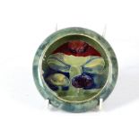 AN EARLY 20TH CENTURY WILLIAM MOORCROFT POTTERY INVERTED RIM CIRCULAR DISH, dated Oct. 1913, green