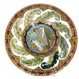 CARLO MANZONI, ITALY, a late 19th century pottery charger, painted on the border with sgraffito