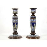 A PAIR OF LATE VICTORIAN DOULTON LAMBETH STONEWARE CANDLESTICKS, tube-lined in low relief with