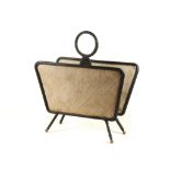 A 1950'S MAGAZINE RACK, designed by Jacques Adnet, with black leather clad steel frame and wicker