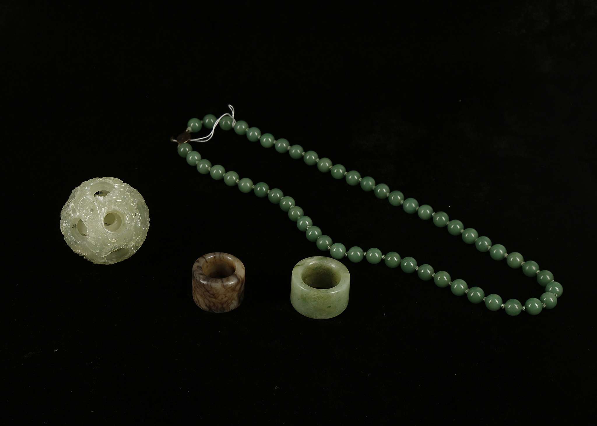 A green jade Chinese puzzle ball, 5.5cm diameter approx. jade necklace with silver clasp, green