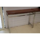 A pair of tan leather and polished steel hall tables, 91 x 120 x 40cm (2).