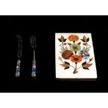 A Pietra Dura panel, floral study, and an enamelled handle knife and fork (3), 15.3 x 10.4cm.