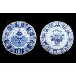 TWO DUTCH DELFT BLUE AND WHITE CHARGERS, 18th century, the first be the De Klaauw factory, decorated