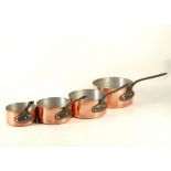 A graduated set of 5 copper saucepans, iron handles, largest 18.3cm diameter.