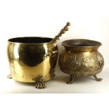 A brass log pot, strap work and copper studs, lion paw feet, 41.5cm diameter, 1920's brass