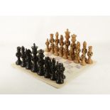 A Cantonese carved wood chess set, each piece incorporating puzzle balls, height of king 15.75cm,