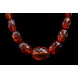 An amber necklace, comprised of 49 graduated faceted beads. L: 60cm Weight, 29g