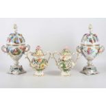 A pair of Dresden 19th century lidded bon bon dishes with painted and applied flowers, the lids