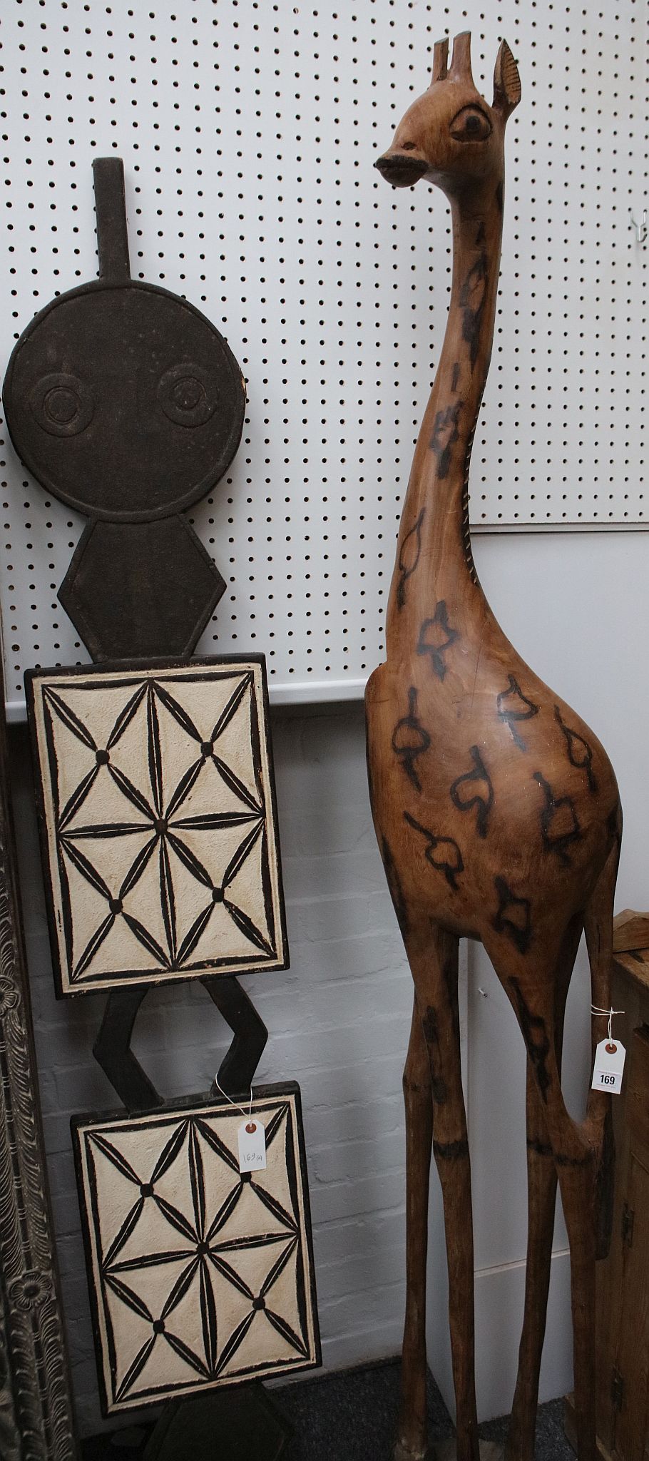 A sizeable wood giraffe, 210cm high, and a large African head crest.