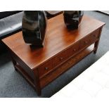 A pair of mahogany lounge stands, open tier with shaped apron over single drawer set on block