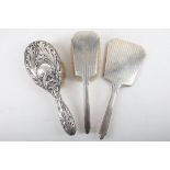 Two Silver backed dressing table hair brushes and a hand mirror. (3)