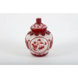 A Chinese overlay red glass box and cover, with panels of sea creatures between Shou characters,