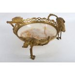 An early 20th Century onyx and gilt standing dish, the onyx bowl supported within a pierced gilt