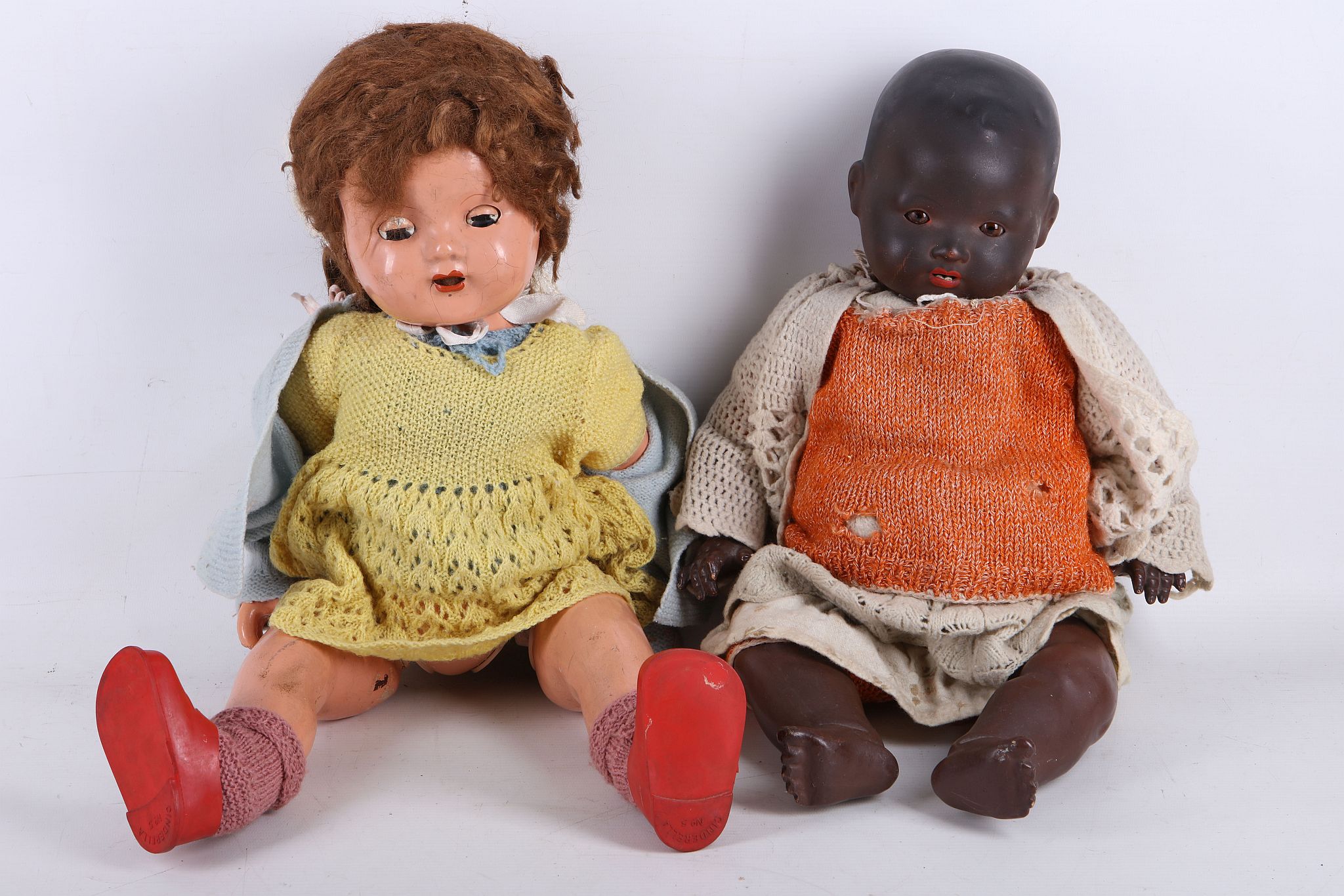 An Armand Marseilles black childs' doll, 50cm high, together with a composition head and baby girl