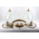A pair of deep clear glass hanging lanterns, complete with gilt support rings, chains and lighting