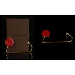 LOUIS VUITTON HANDBAG HOOK, gilt metal with red leather cushion embossed with logo flower, 12cm