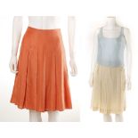 BURBERRY CORAL SILK PLEATED SKIRT, UK size 8, together with a Calvin Klein cream silk skirt, size 10