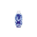 A CHINESE BLUE OVERLAY GLASS ‘CHILONG’ SNUFF BOTTLE. Qing Dynasty. Each side carved with a