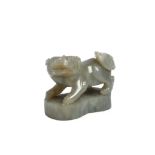 A CHINESE JADE CARVING OF A BUDDHIST LION DOG. Qing Dynasty. Standing with the head and tail