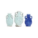 TWO CHINESE CELADON AND ONE BLUE-GLAZED SNUFF BOTTLE. Qing Dynasty. Each with looping handles on the