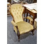 Two Victorian mahogany spoon back easy chairs, with button back on cabriole legs.