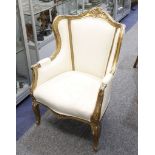 A continental giltwood armchair on cabriole legs.