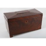 A George III mahogany tea caddy of coffer form, the hinged lid rising to reveal twin lidded