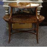 An Edwardian Sheraton two tier oval table with painted decoration.