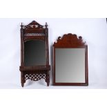 A Georgian style mahogany mirror with shaped pediment, sold with and Edwardian mahogany mirror