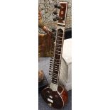 An Indian sitar and case (with instructions) stringed instrument (modern 2002).