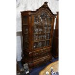 A Dutch walnut display cabinet, with glazed door over bombè form base with three drawers, 112cm