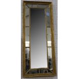 A giltwood border glass pier mirror, circa 1880, 140 x 57cm.