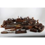 A quantity of antique carpenters tools, mainly moulding planes with chisels and a whetstone,