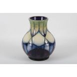 A modern Moorcroft baluster shaped vase with purple, blue and green / cream, tube lined