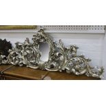 Two rococo silvered wood door pediments with central mirrors.