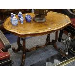 A Victorian walnut centre table, with cartouche shaped top on twin end cabriole supports, 121cm