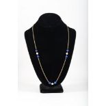 A 14 carat yellow gold, lapis lazuli, and pearl necklace, having rope twist chain, suspended three