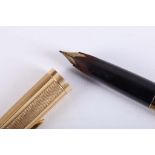 An 18 carat yellow gold Montblanc pen, having engine turned decoration. L: 13.8cm