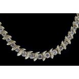 A 14 carat yellow gold and diamond articulated collar necklace, having graduated round cut stones